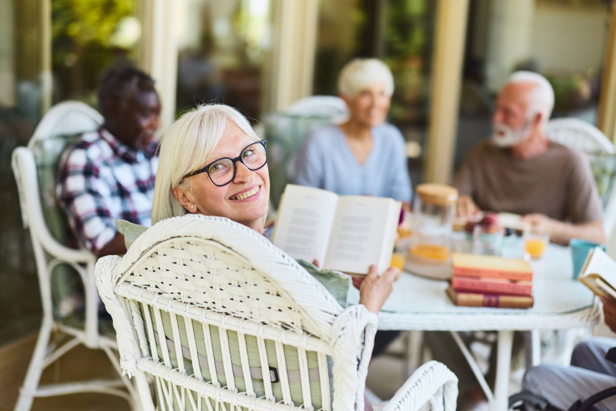 A woman proudly shows her published book